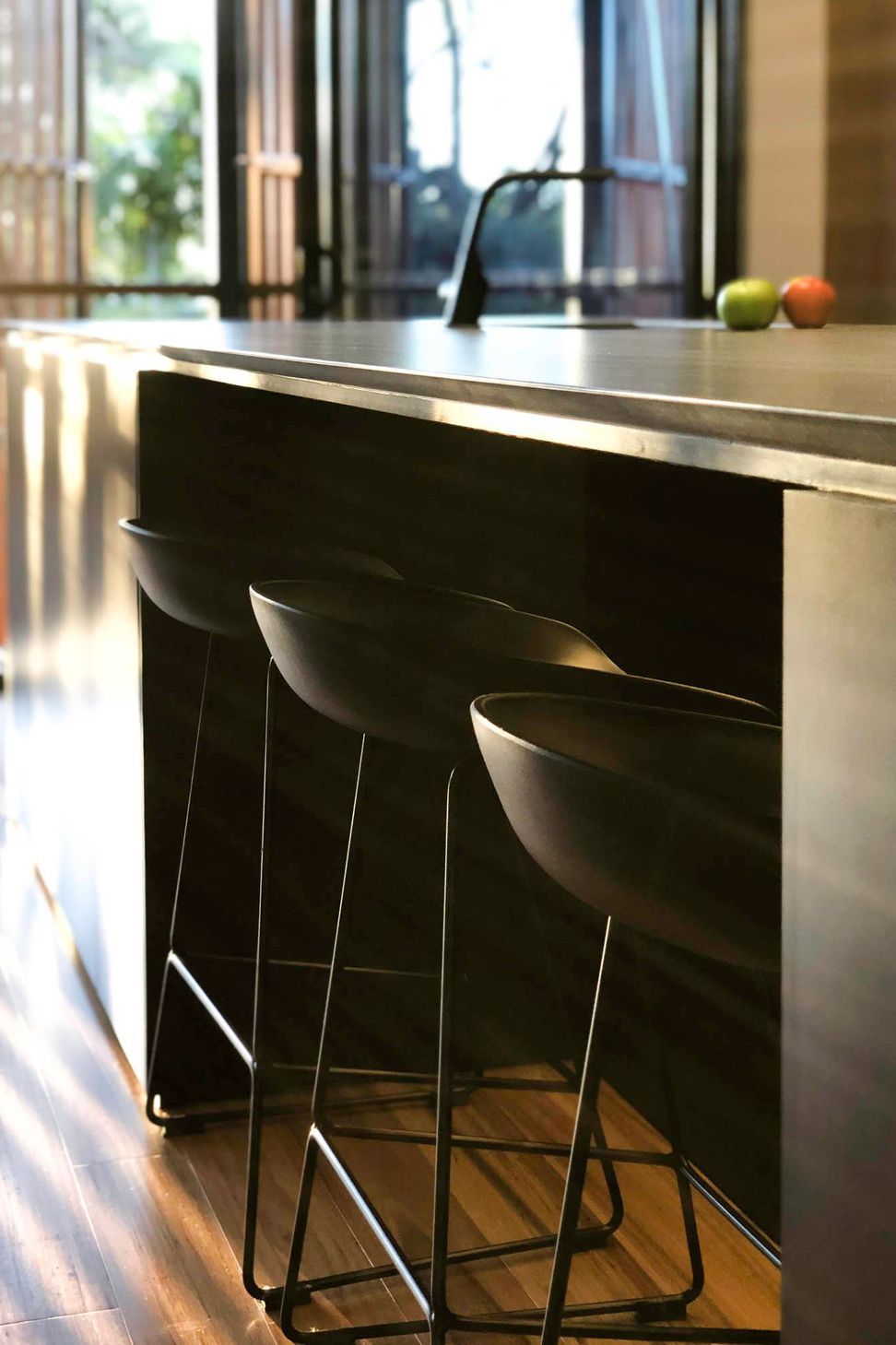 Glennon Residence - Kitchen. Bar stools beneath the dark island bench.
