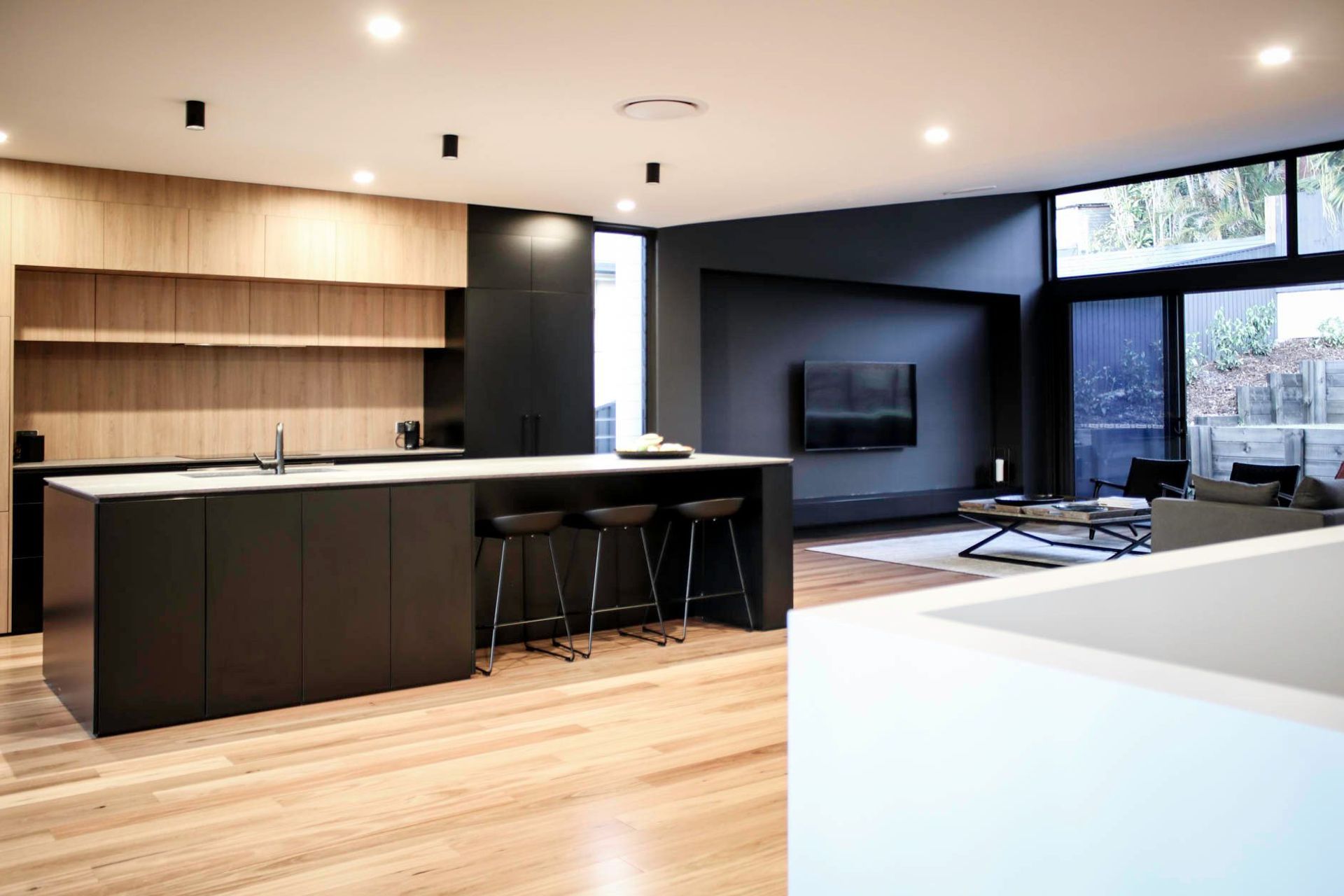 Glennon Residence - Kitchen. Kitchen with timber shelving and dark joinery.