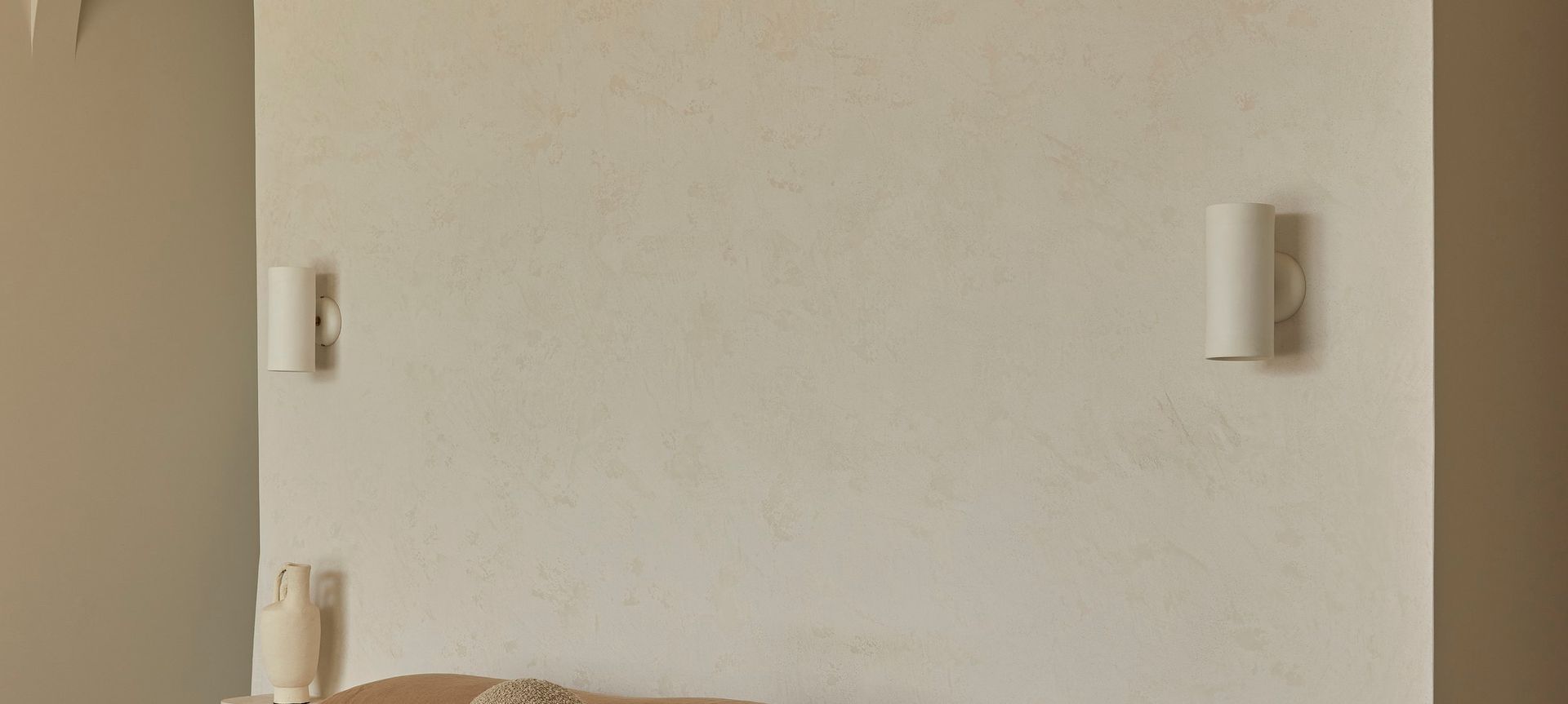 Studio Enti’s Eos Wall Lights beautifully blending with the natural palette of the home.