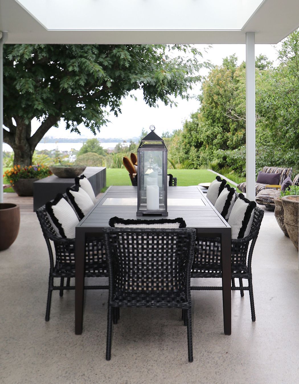 Custom made outdoor table in Iroko timer & silver travertine stone centre piece