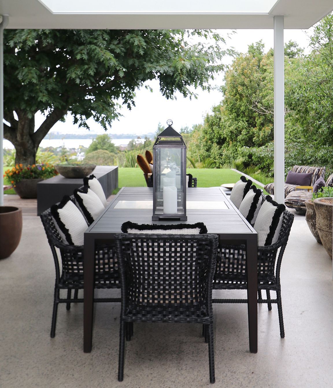 Custom made outdoor table in Iroko timer &amp; silver travertine stone centre piece