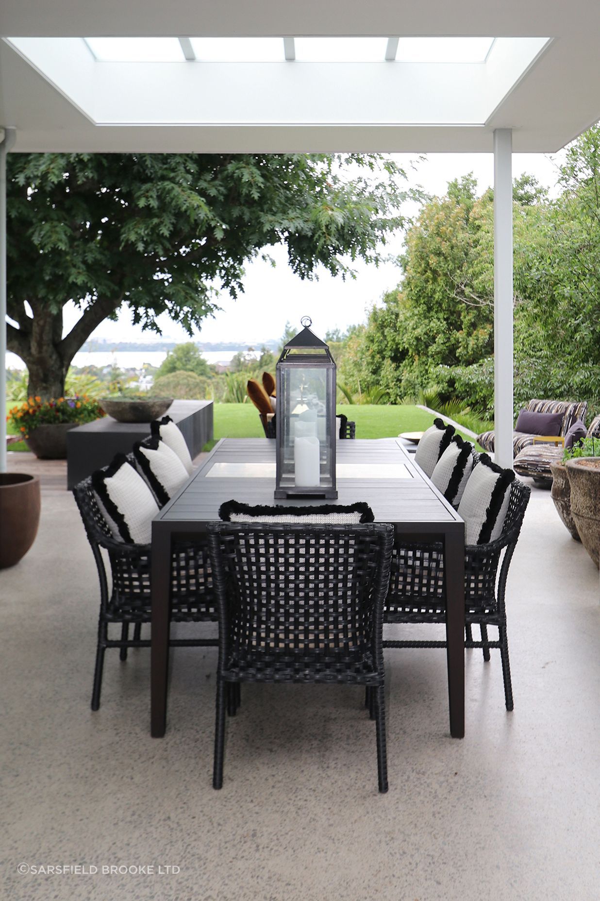 Custom made outdoor table in Iroko timer &amp; silver travertine stone centre piece