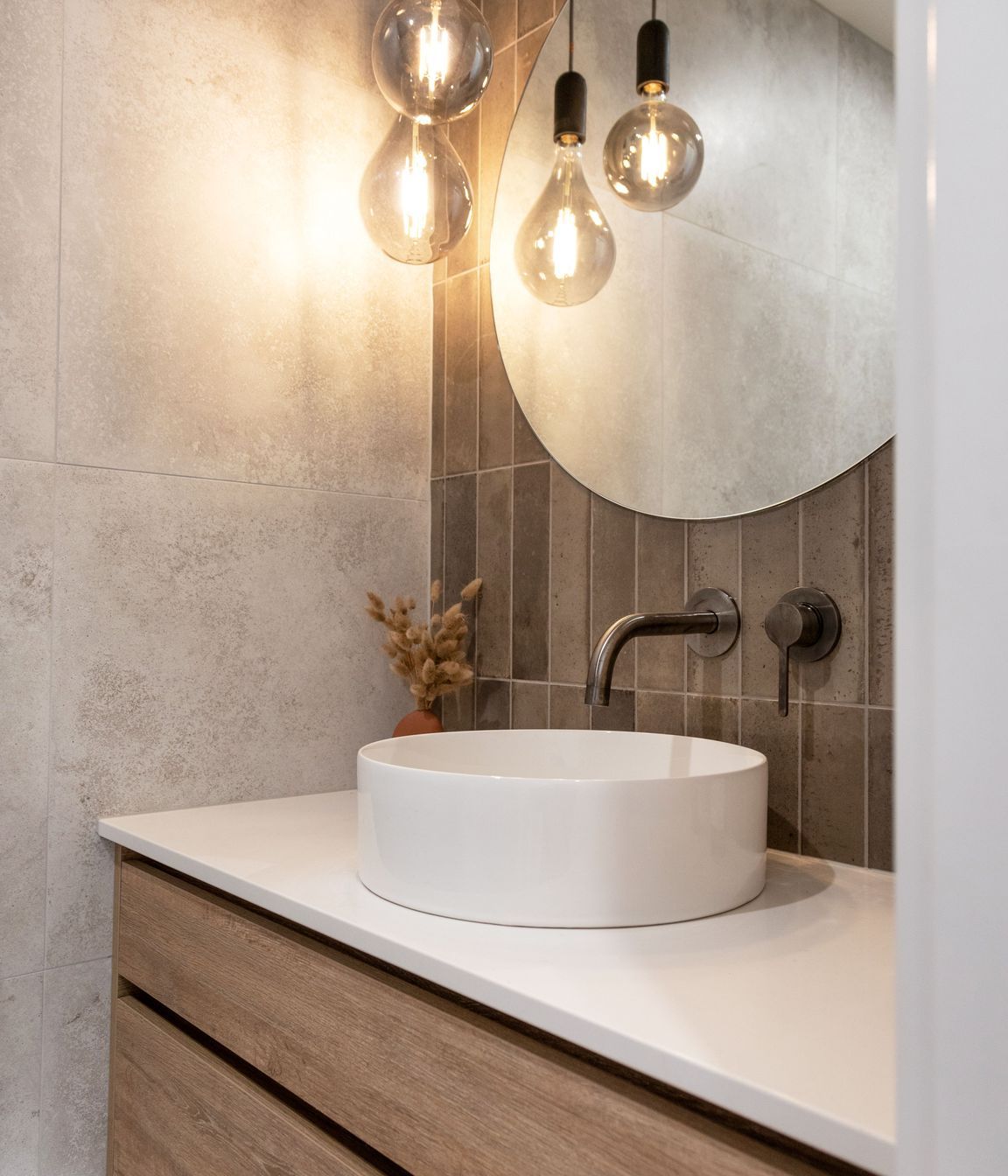 Modern bathroom. Feature lighting with round mirror. Photographer - Sandra Henderson