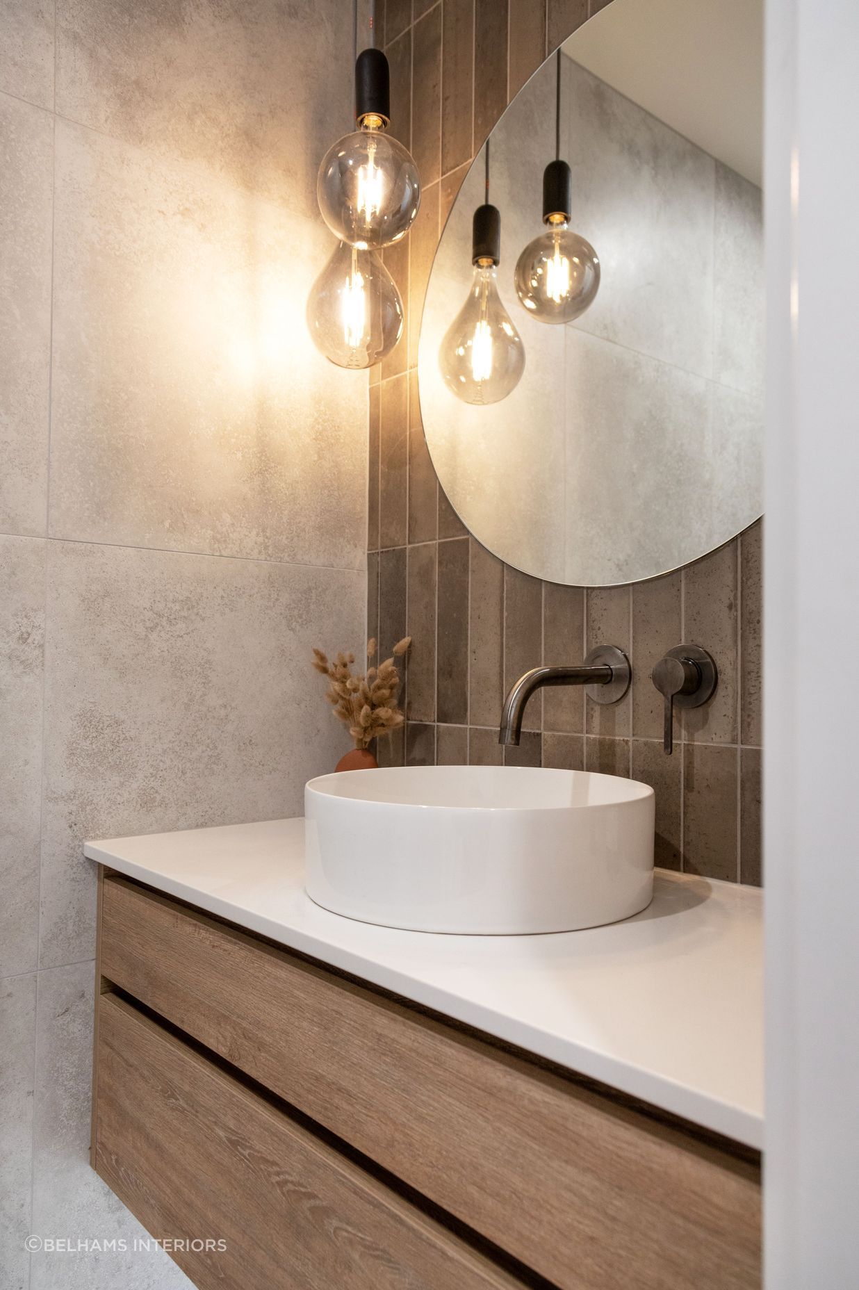 Modern bathroom. Feature lighting with round mirror. Photographer - Sandra Henderson