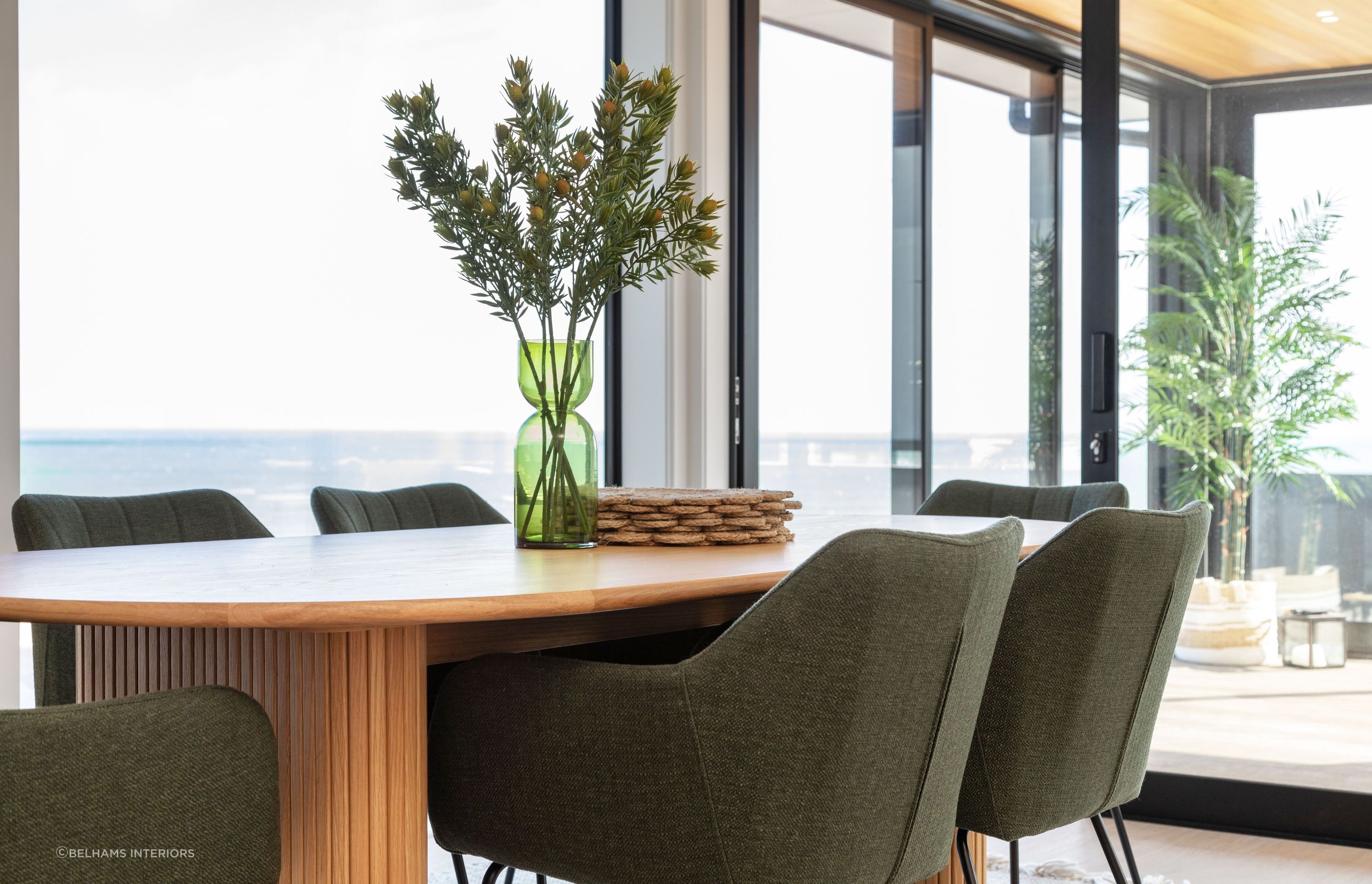 Dining setting with a view. A large family sized dining table was a must for this home with an open plan designed for social gatherings. Photographer - Sandra Henderson.