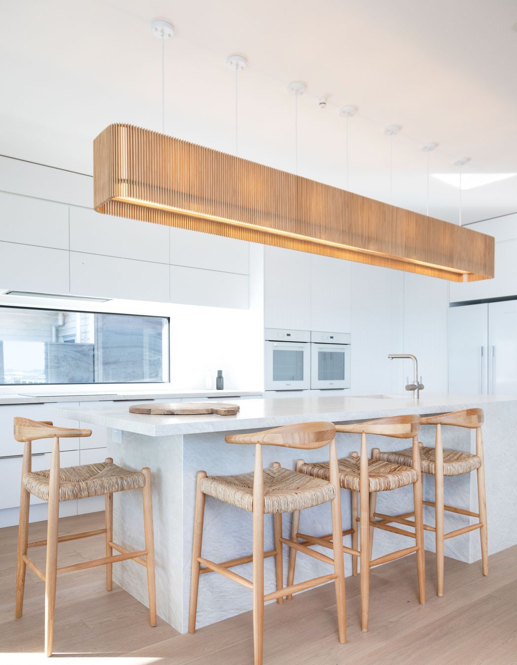Minimalist kitchen design with wooden accessories. Photographer: Sandra Henderson.
