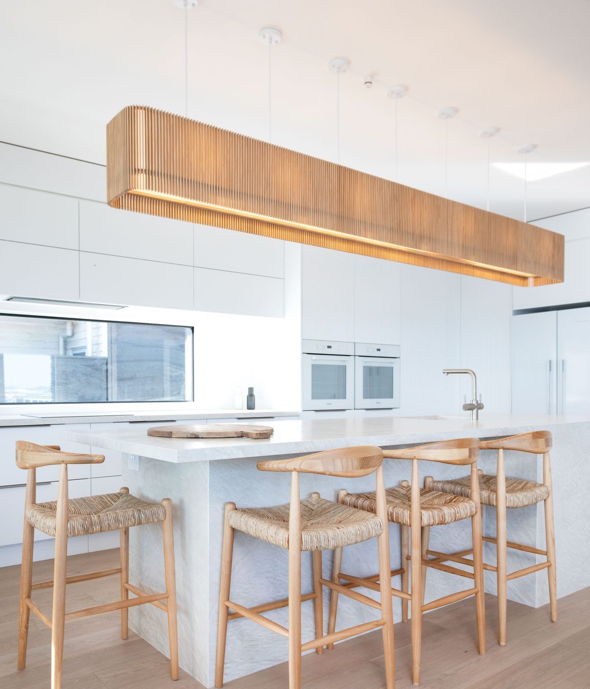 Minimalist kitchen design with wooden accessories. Photographer: Sandra Henderson.