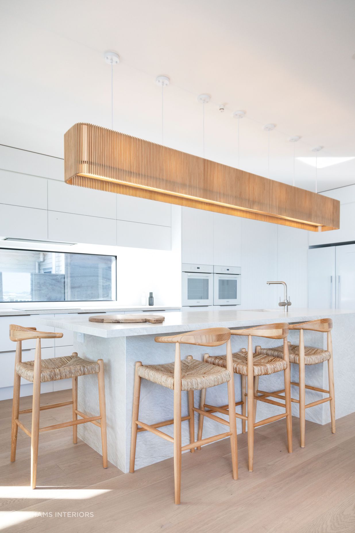 Minimalist kitchen design with wooden accessories. Photographer: Sandra Henderson.