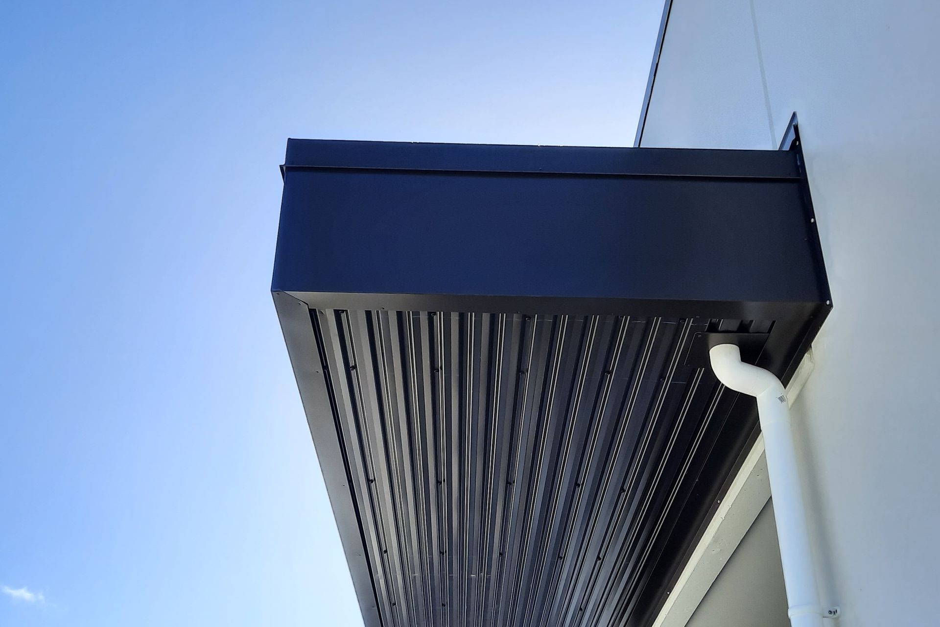Eye-brow canopy roofs feature over entrances to shops