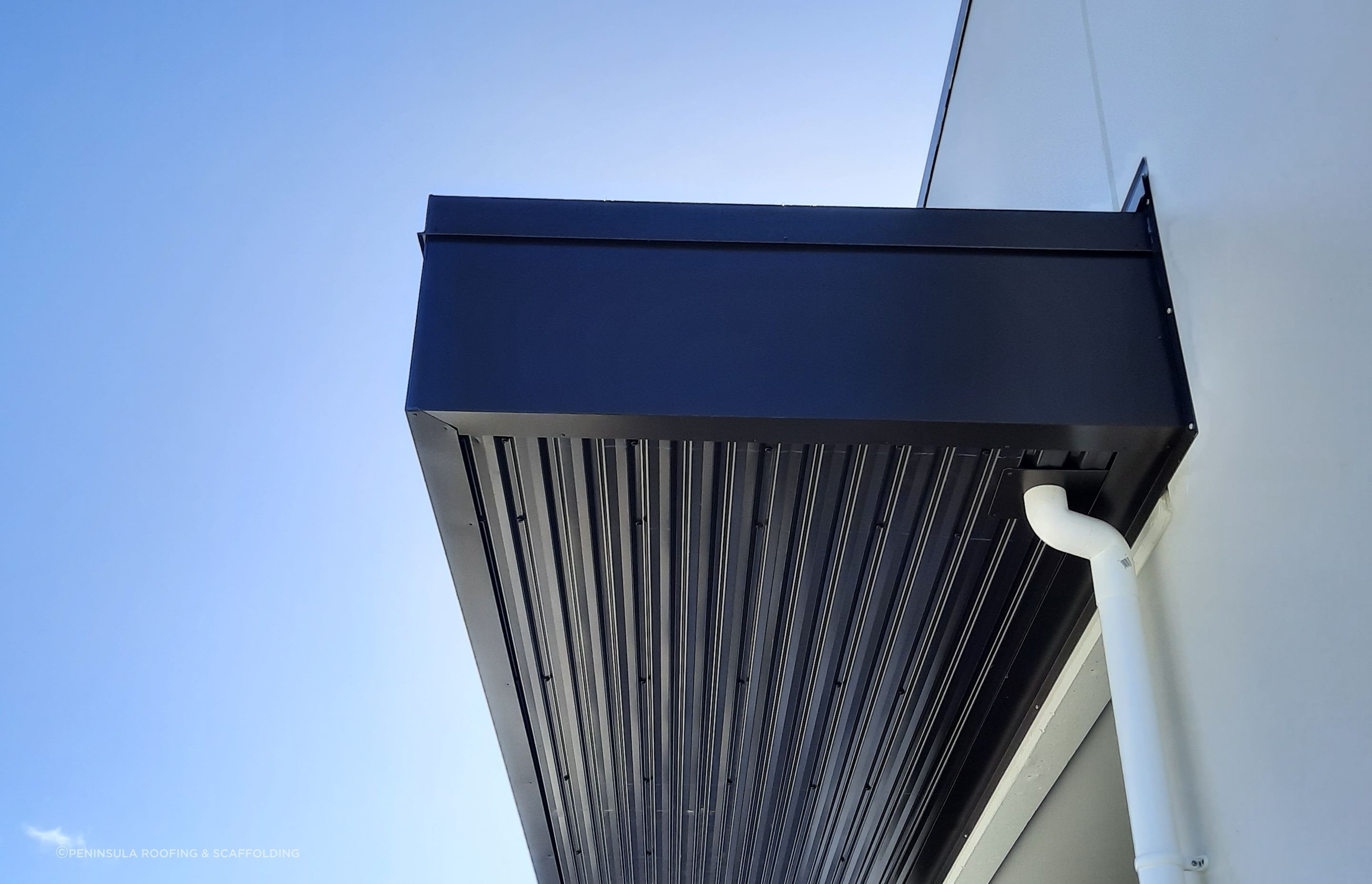 Eye-brow canopy roofs feature over entrances to shops