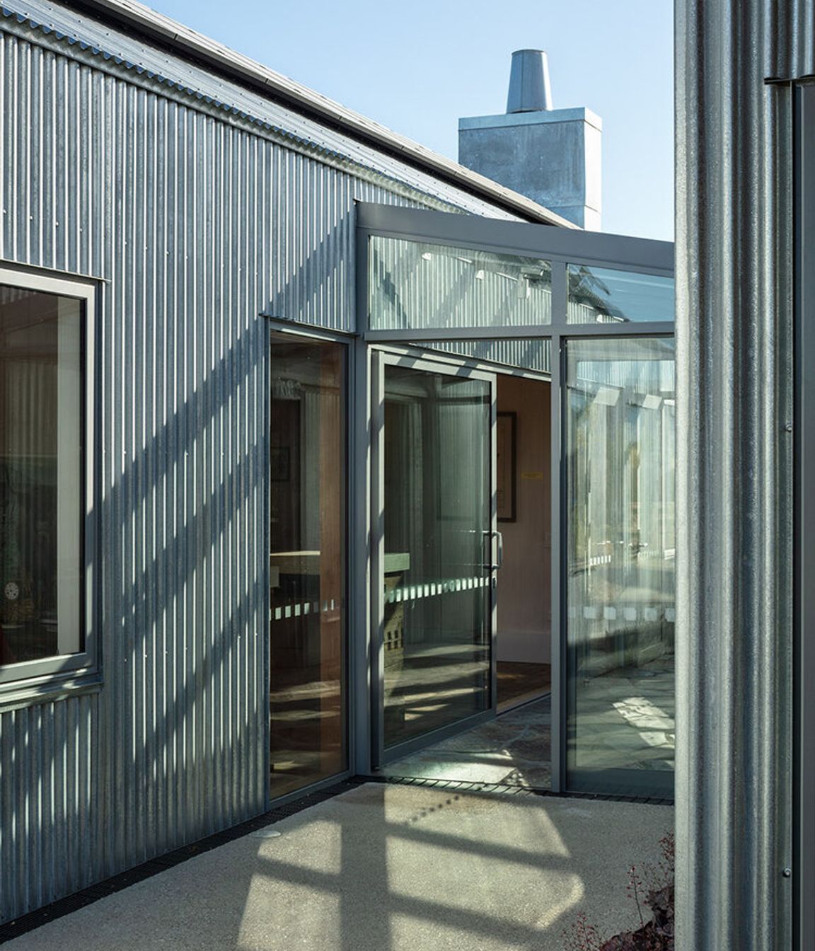 The glazed entry foyer is the connection between the two buildings.