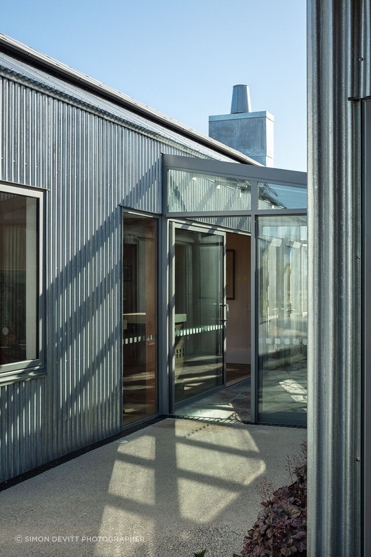 The glazed entry foyer is the connection between the two buildings.