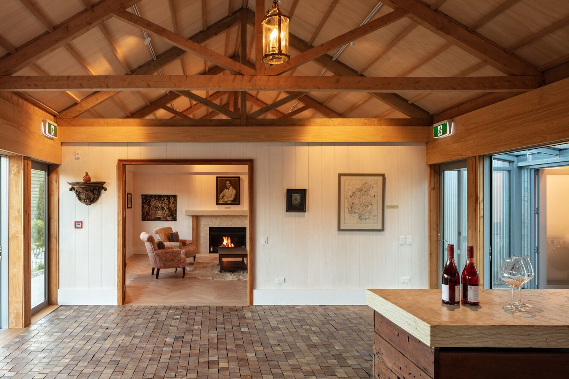 The cosy library room features a fireplace and herringbone parquet floors.
