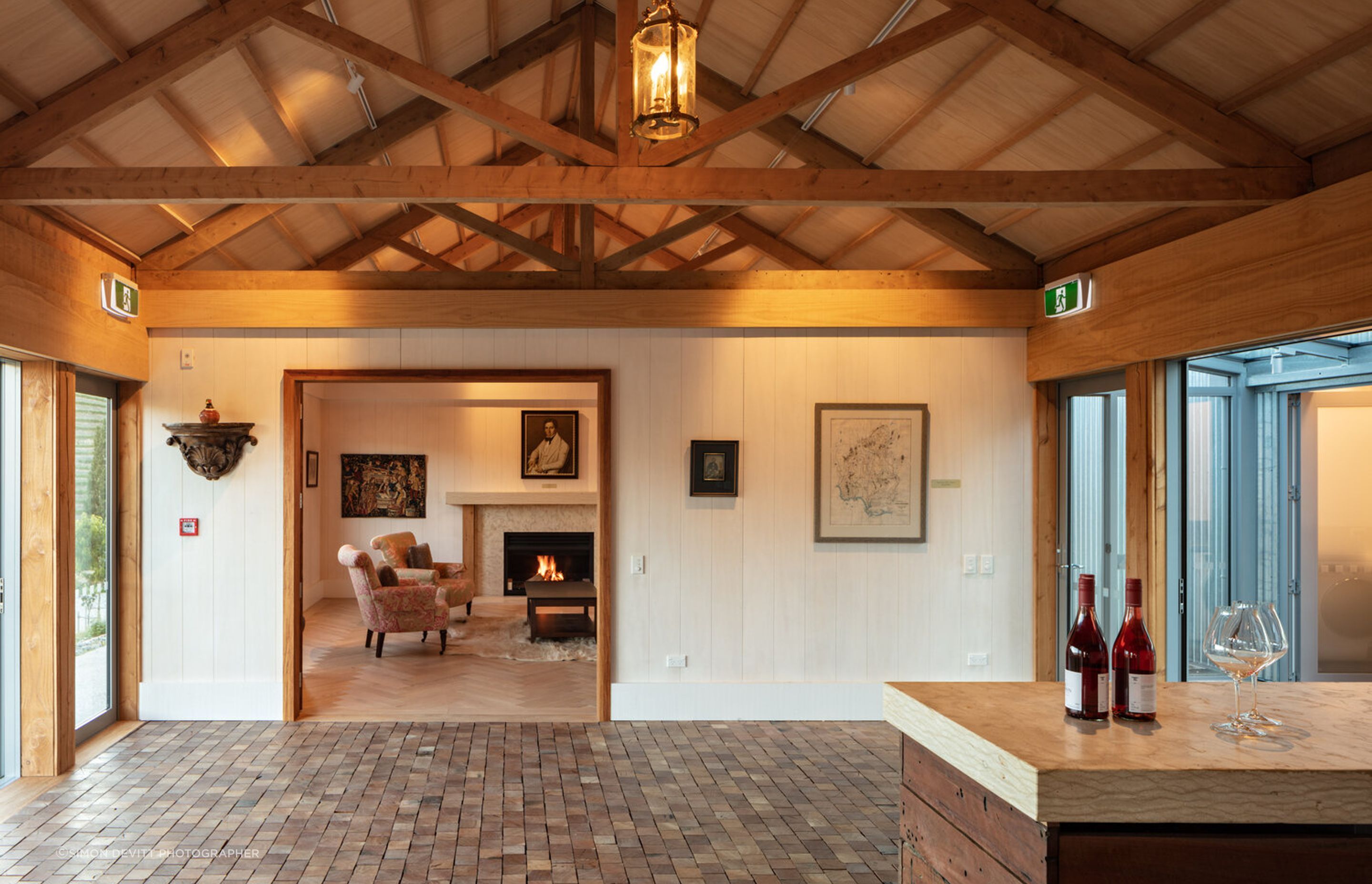 The cosy library room features a fireplace and herringbone parquet floors.