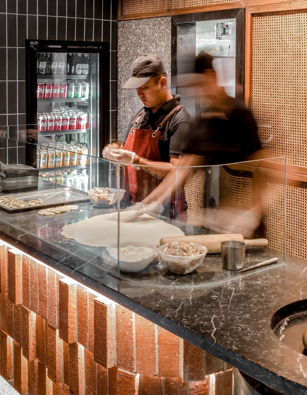 The service counter's layered effect using Rustic Red brick tiles and custom cut bricks