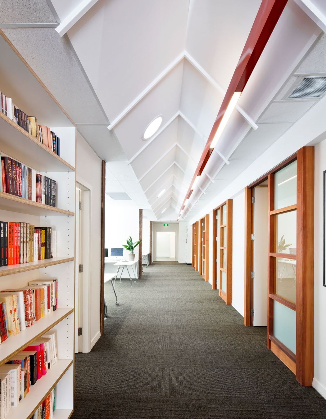 Pitched ceiling opens up the connection spaces within the office