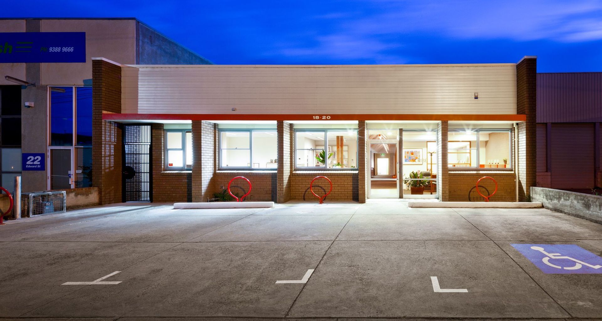 External view of 70’s single level office. Much of the outside remains – just the red bicycle racks signify the extensive internal renovations.