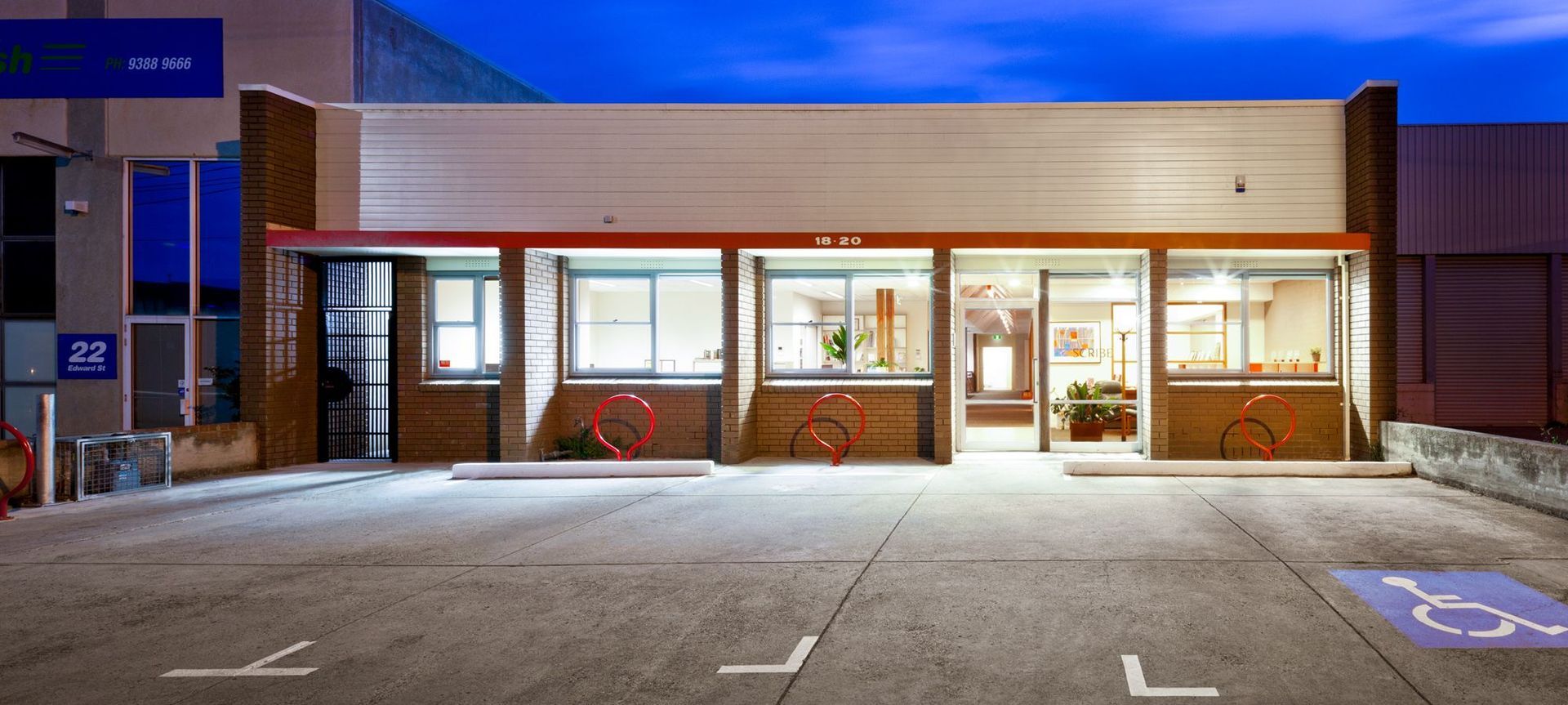 External view of 70’s single level office. Much of the outside remains – just the red bicycle racks signify the extensive internal renovations.