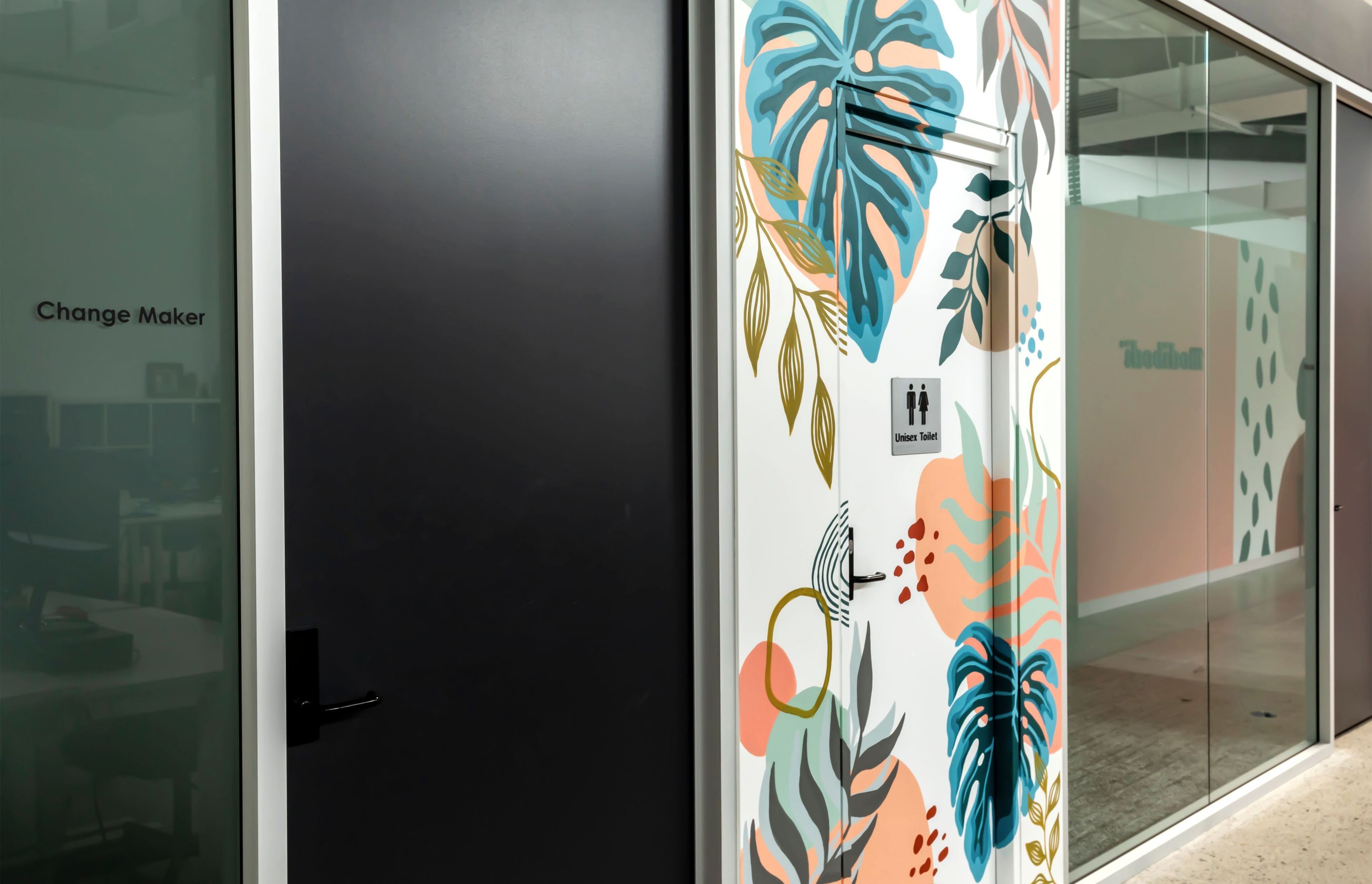Base building bathroom dressed in colourful murals symbolising 'the entry to a retreat'.