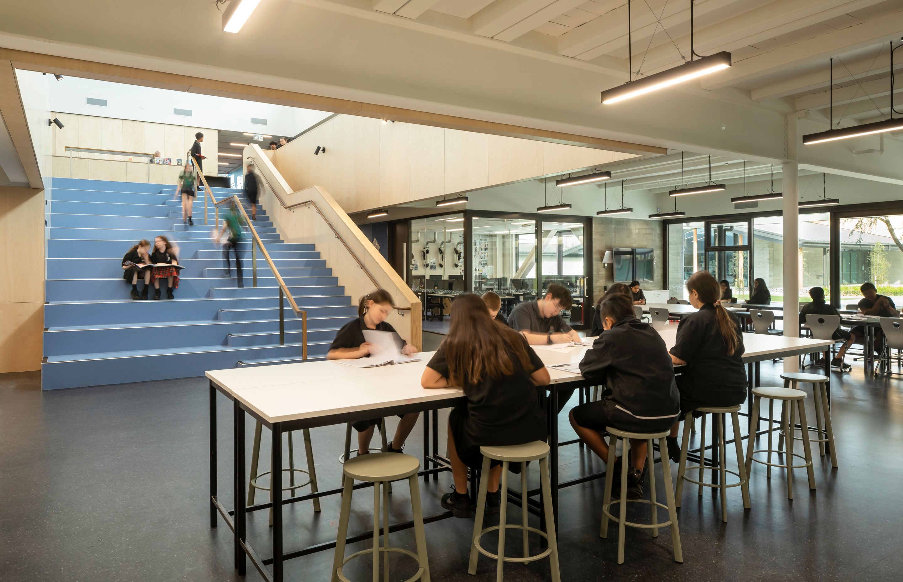 Students work in open-plan break-out spaces in the 'maker' hub.