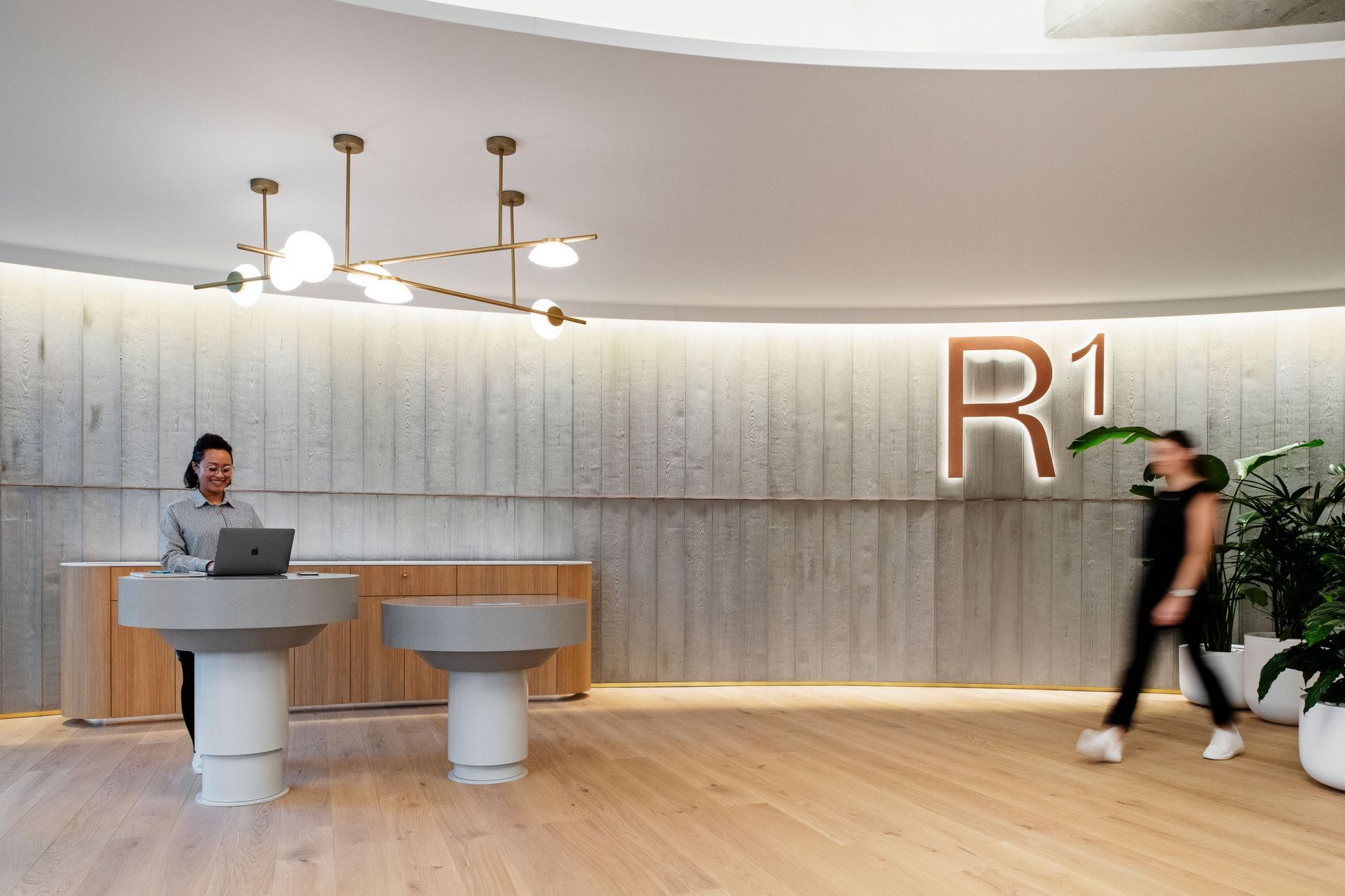 Curved panels of Board Form Veneer reference the shape of the core elements of Reece's product portfolio