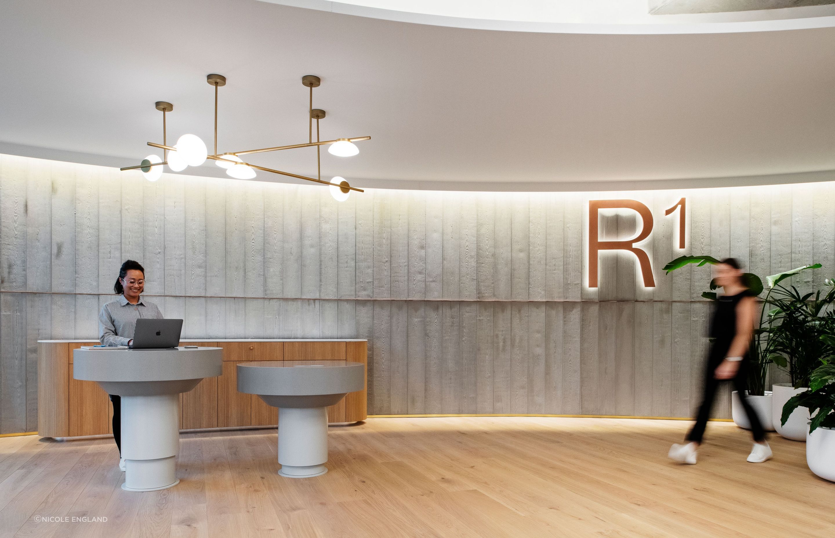 Curved panels of Board Form Veneer reference the shape of the core elements of Reece's product portfolio