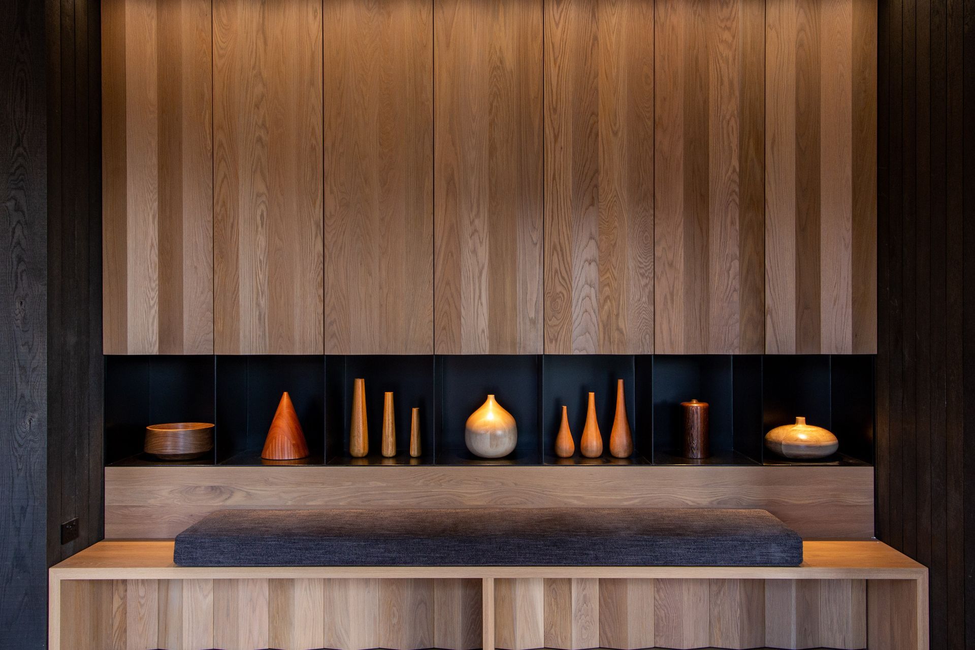 The black painted steel is designed to be recessive and let the turned wood pieces feature.