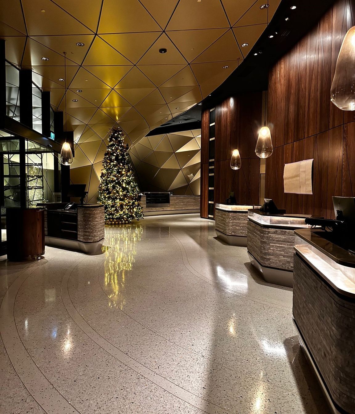 Brass bar laid into the flooring during the installation process naturally creates a walkway between the front door and reception desks