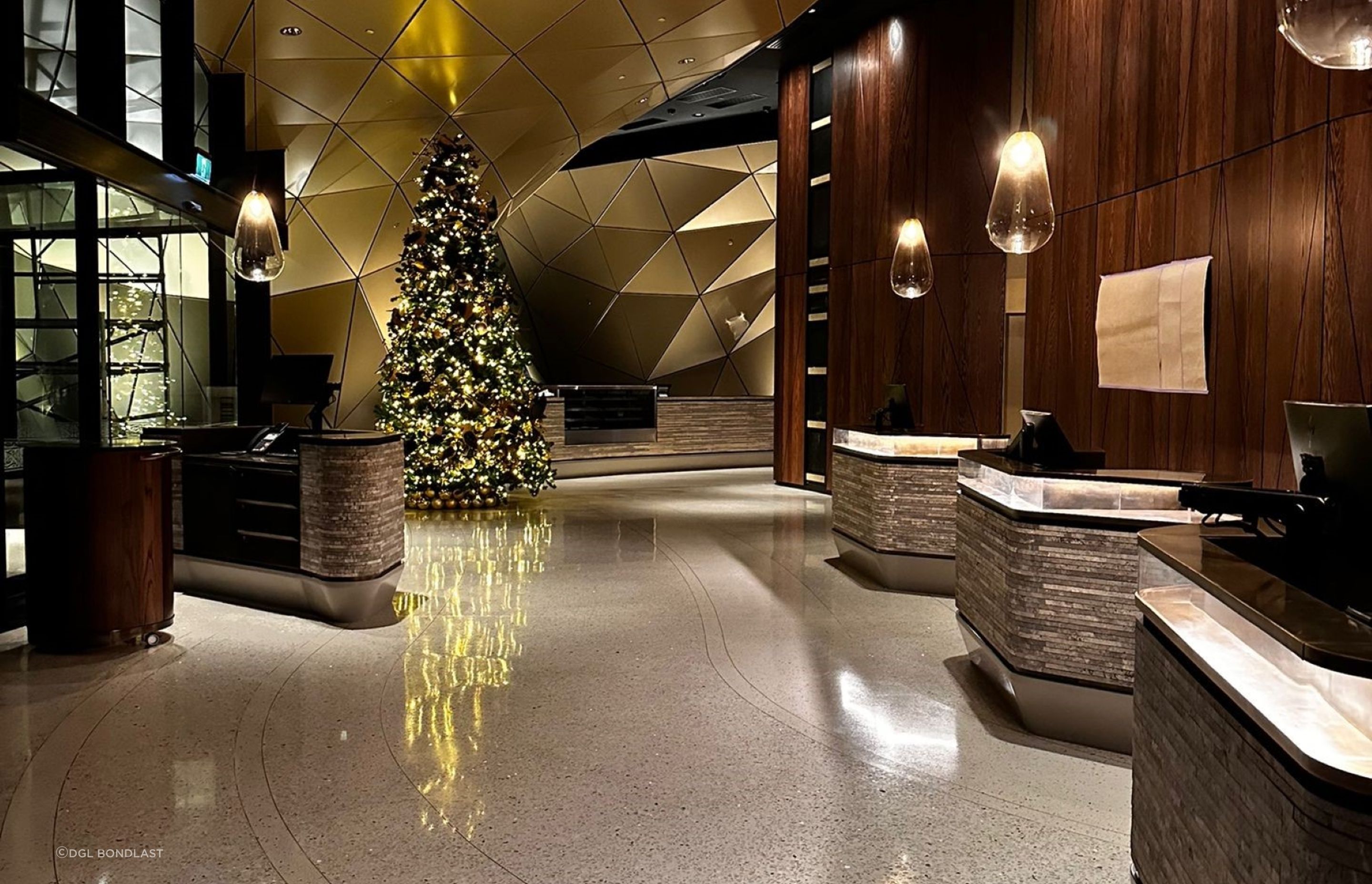 Brass bar laid into the flooring during the installation process naturally creates a walkway between the front door and reception desks