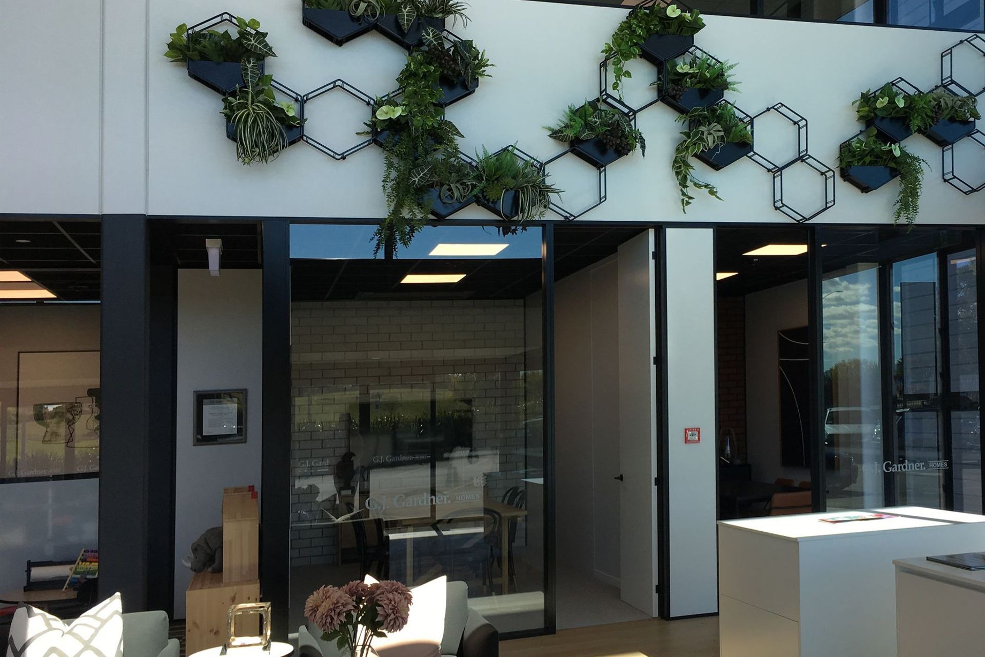 Double height space with plant feature wall
