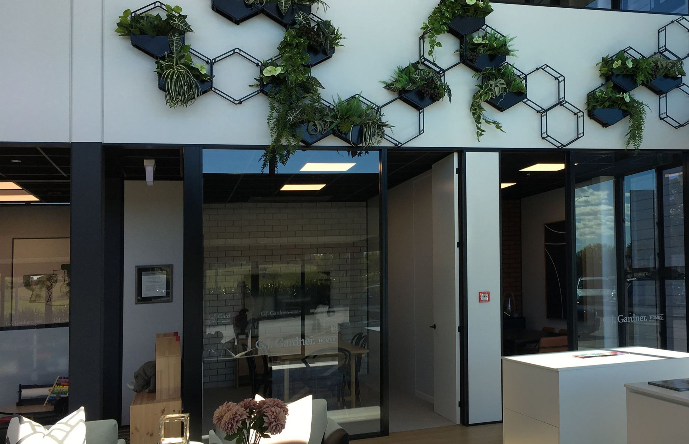 Double height space with plant feature wall