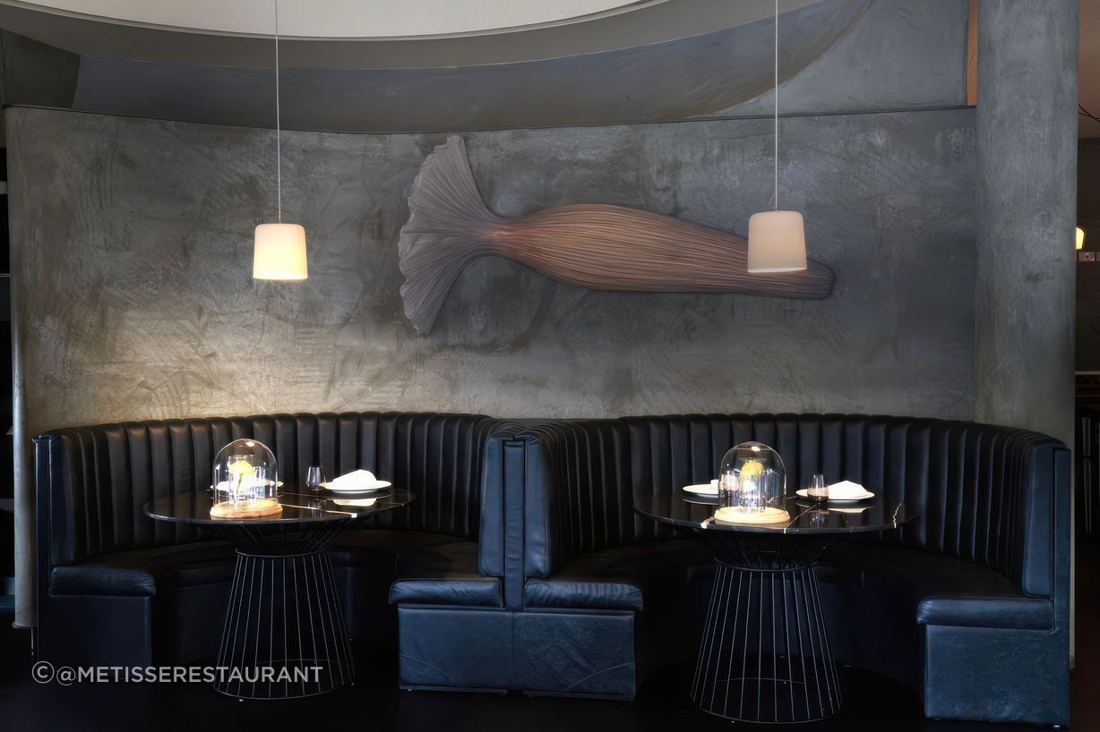The Metisse Dining room - elegantly adorned with our Large Porcelain Dawn Lights in White.