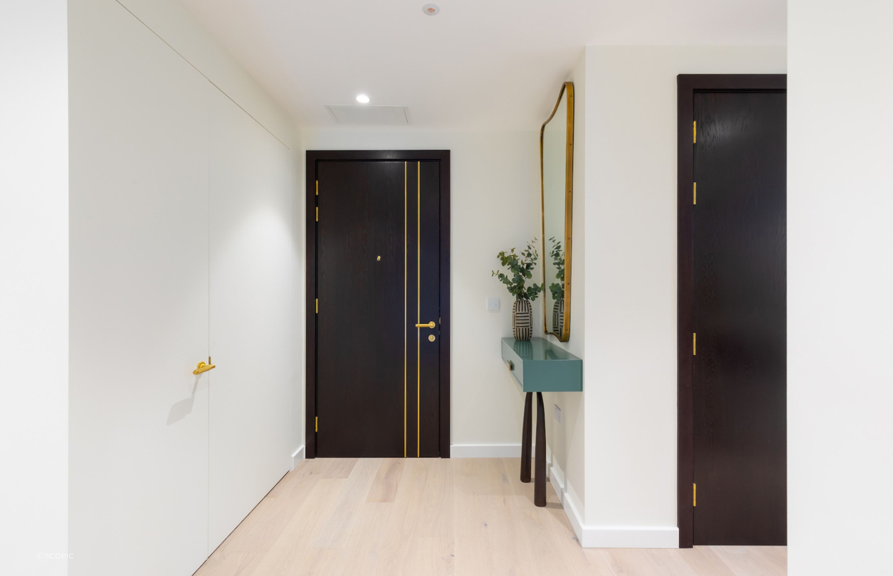 The white wall on the left keeps the entry space uncluttered with an EzyJamb SRC framed double-door.