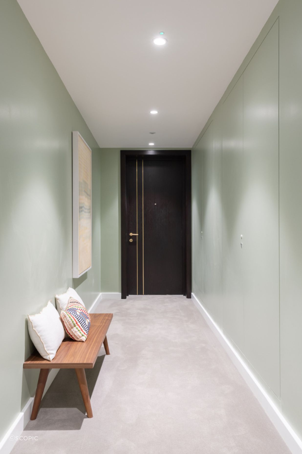 The right-side wall hides servicing panels all along with AccessDor openings painted to match the pale green palette.