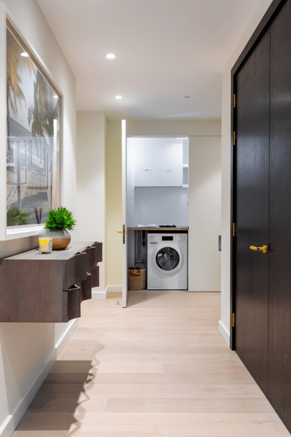 The same door open - revealing the laundry and services space hidden behind.