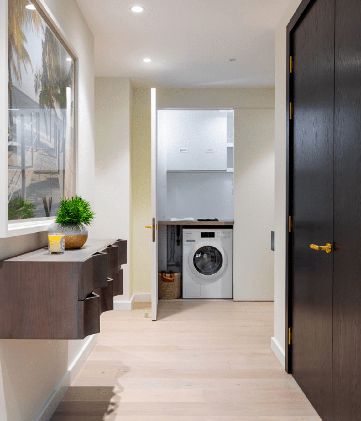 The same door open - revealing the laundry and services space hidden behind.