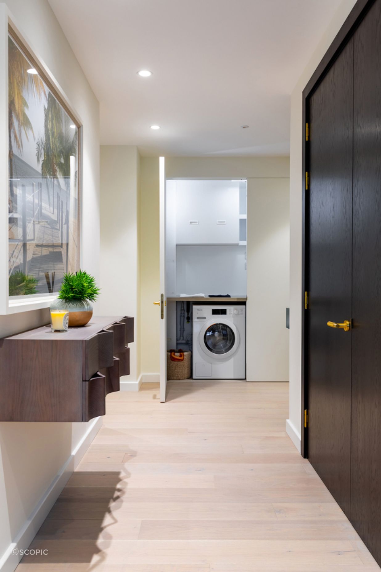 The same door open - revealing the laundry and services space hidden behind.