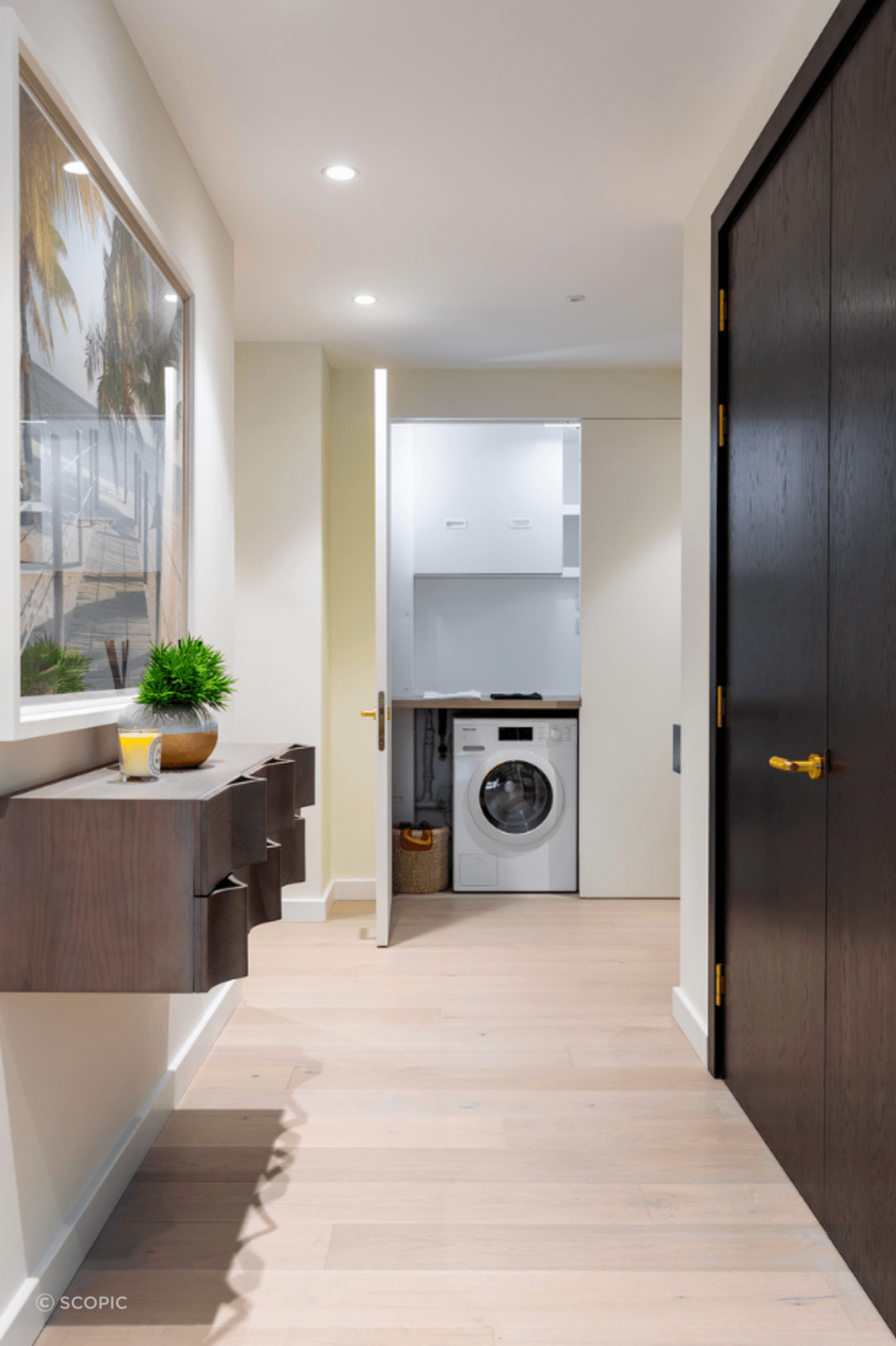 The same door open - revealing the laundry and services space hidden behind.