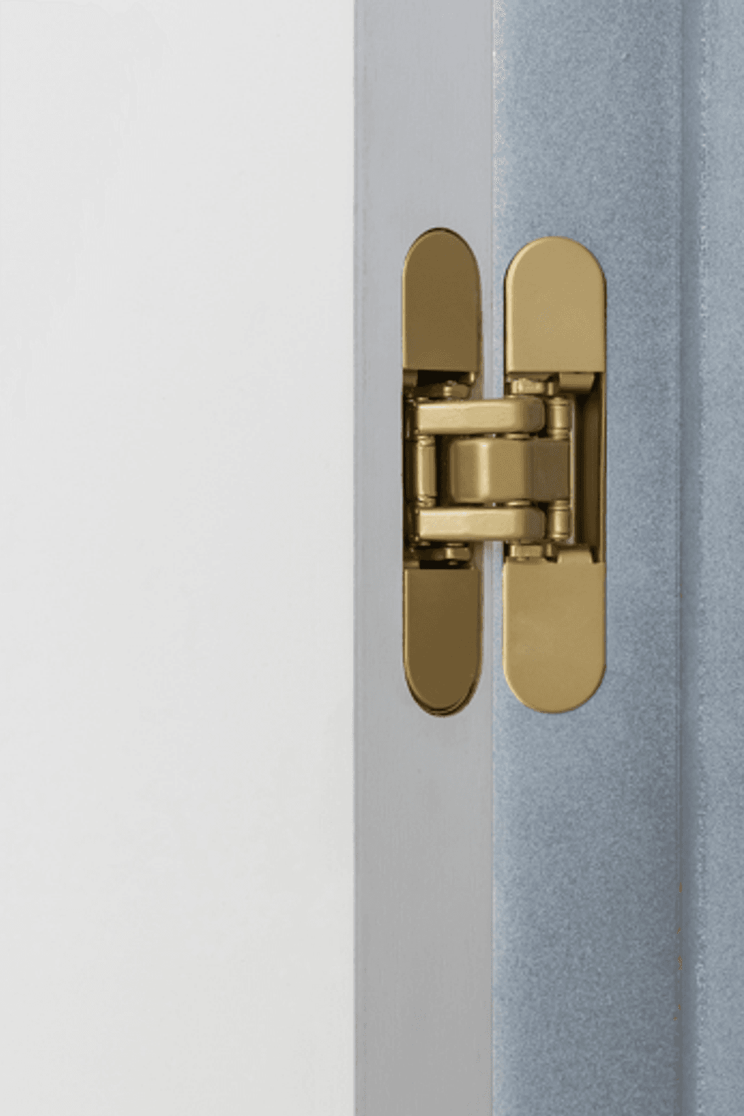 The satin brass RocYork Concealed Hinge on an open door.