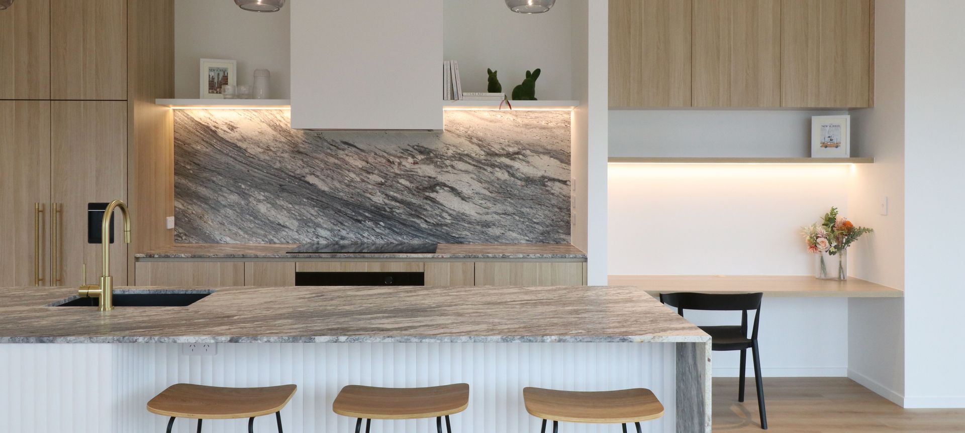 Curved Timber Island with Leathered Granite Elegance banner