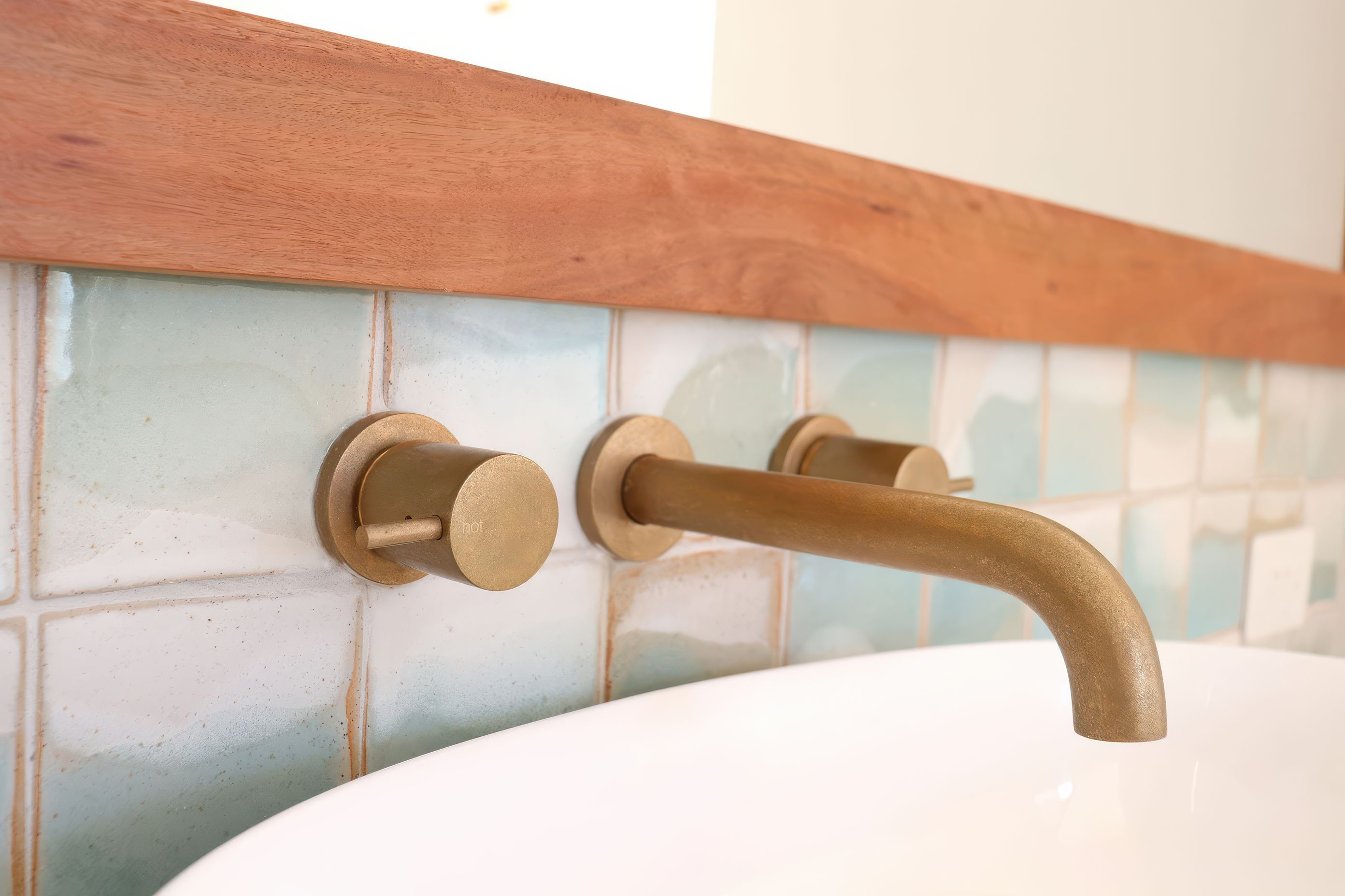 Bathroom Tiles seamlessly tie in with the tap ware.