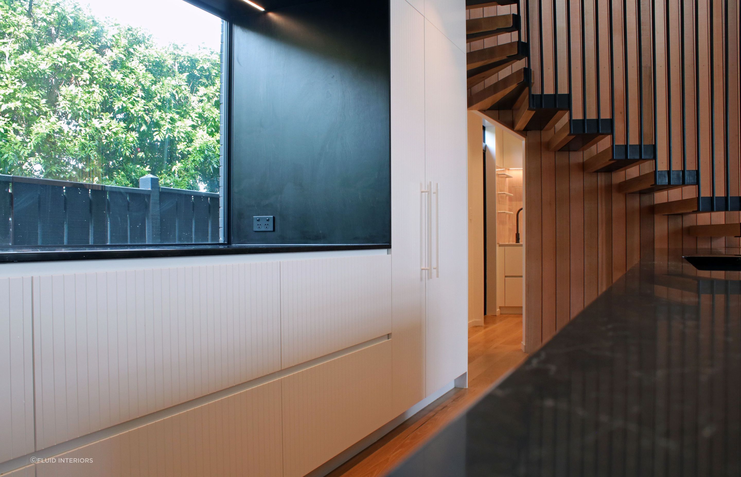 White V groove, black island and a scullery with a touch of pink
