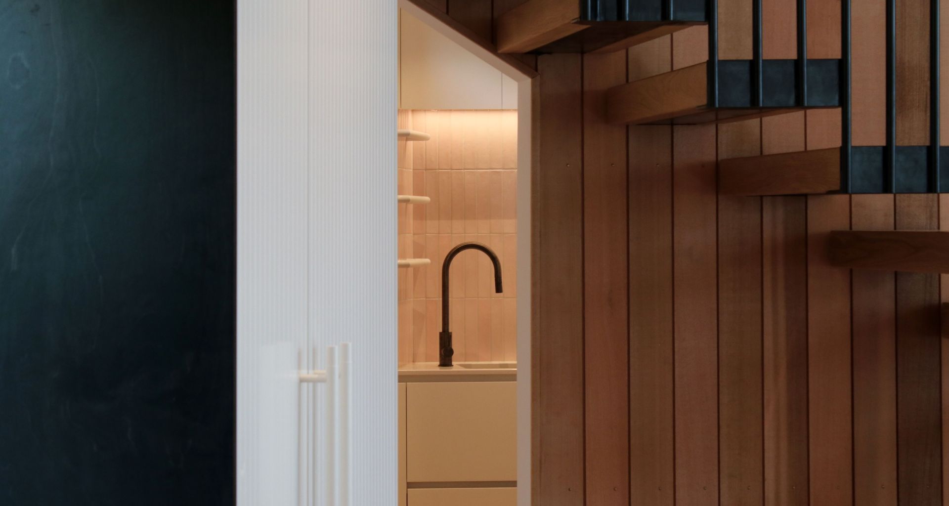White V groove, black island and a scullery with a touch of pink banner
