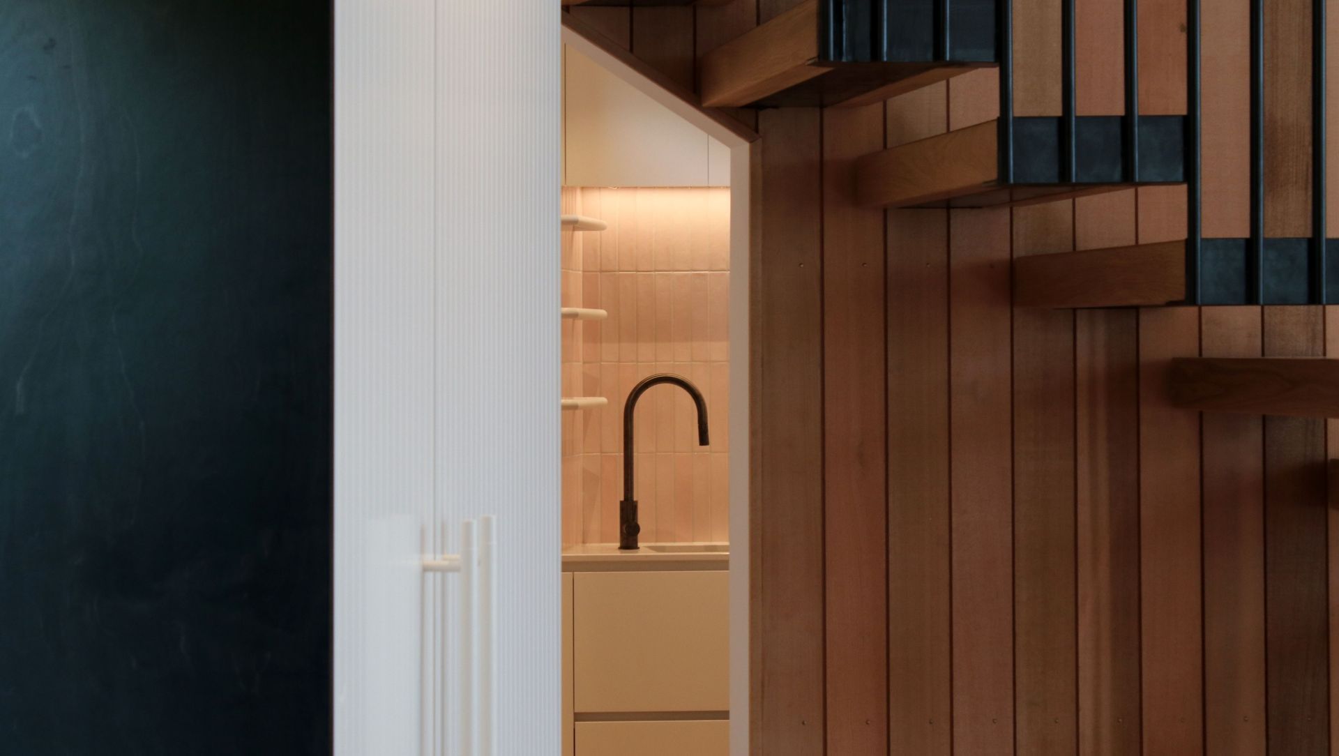 White V groove, black island and a scullery with a touch of pink banner