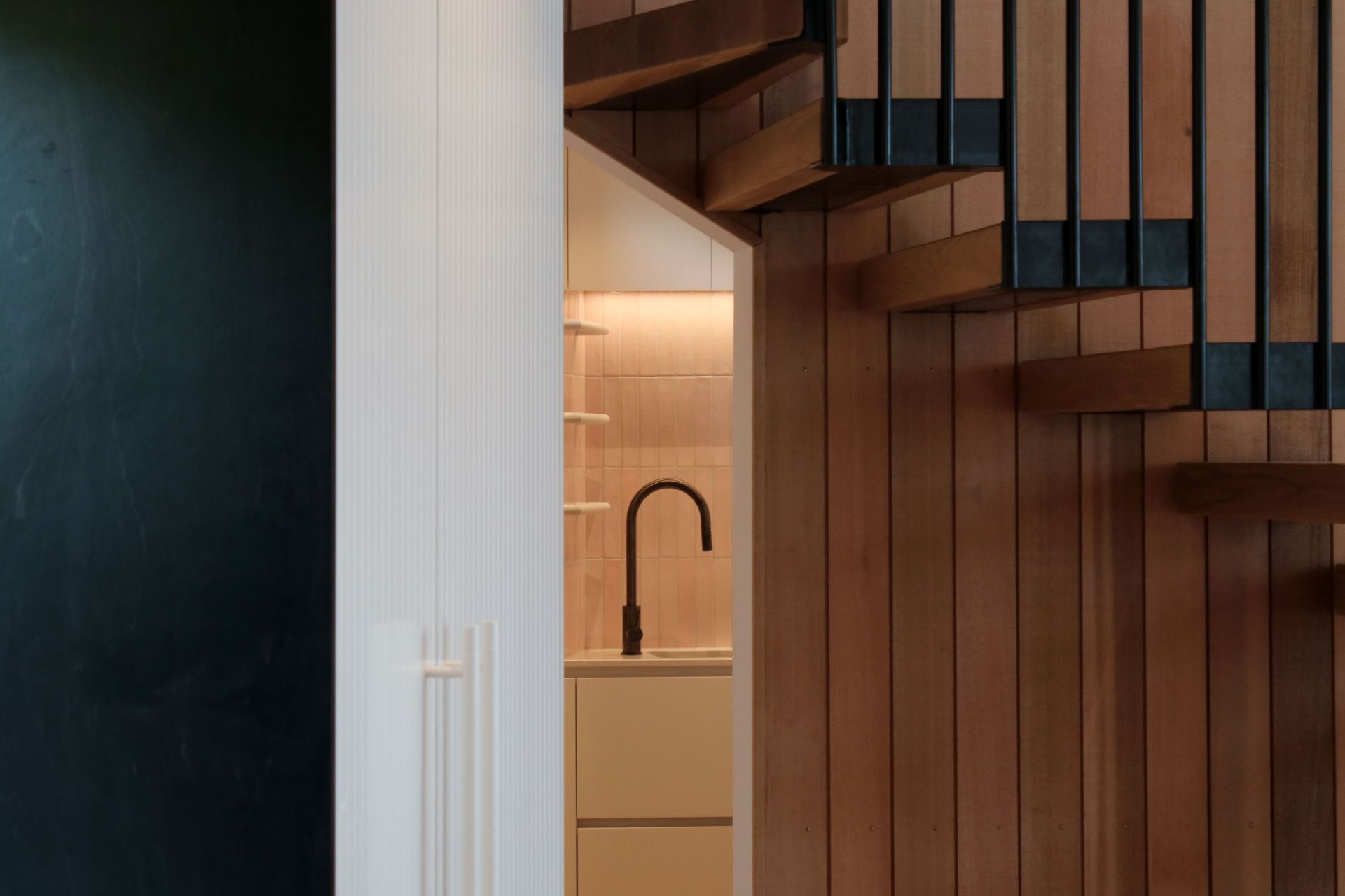 White V groove, black island and a scullery with a touch of pink