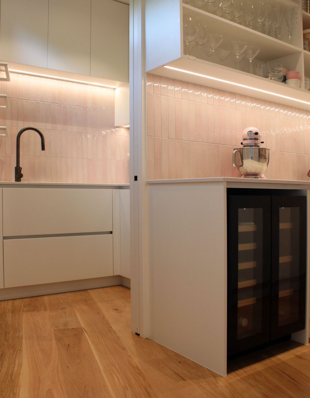 White V groove, black island and a scullery with a touch of pink