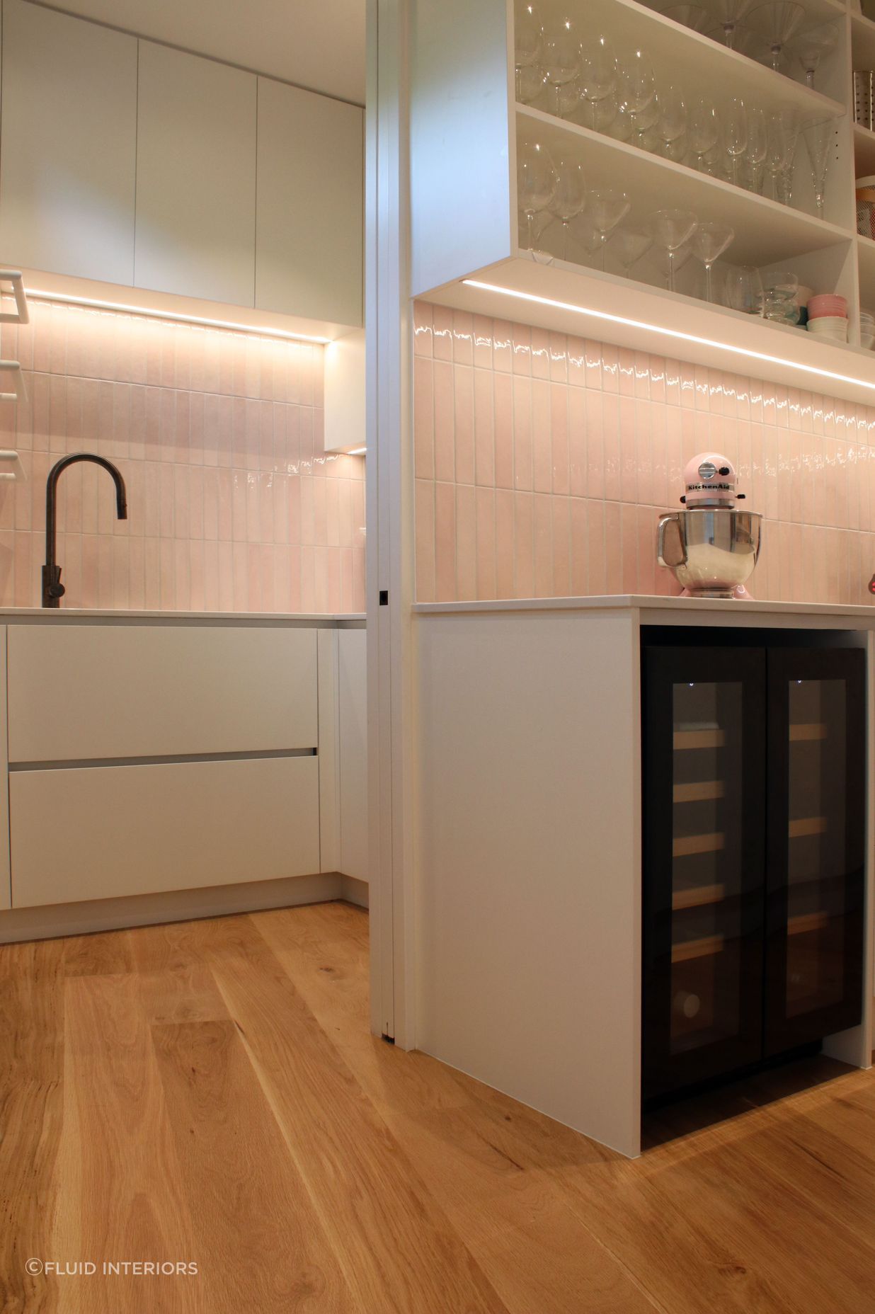 White V groove, black island and a scullery with a touch of pink