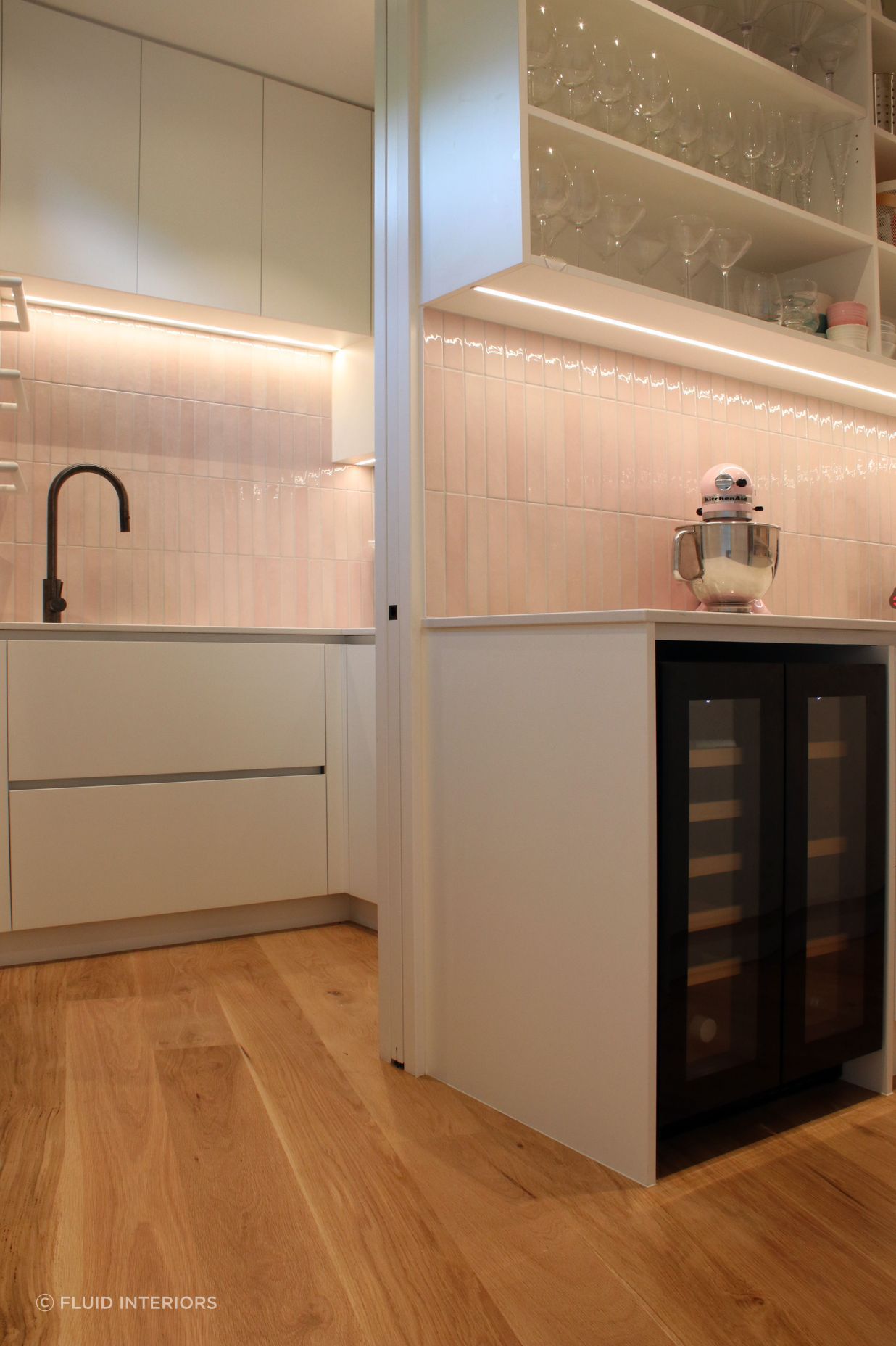 White V groove, black island and a scullery with a touch of pink