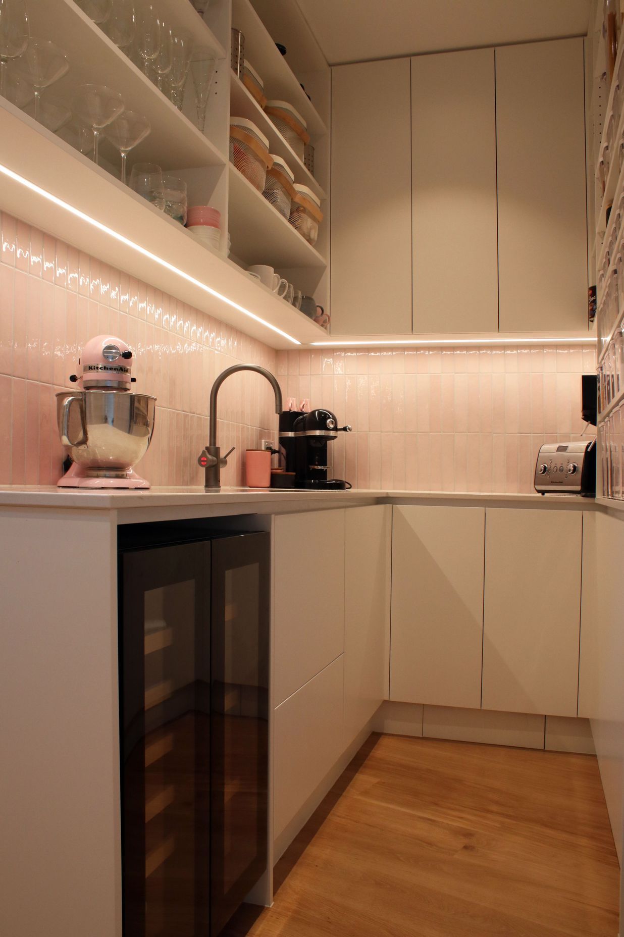White V groove, black island and a scullery with a touch of pink