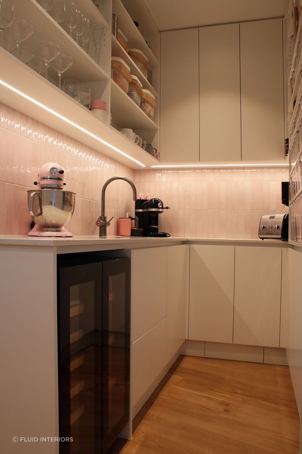 White V groove, black island and a scullery with a touch of pink